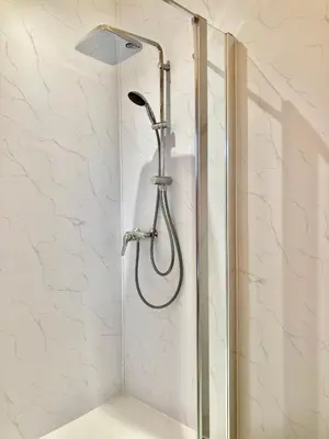 a shower with a shower head in a bathroom at B&B-Les Balcons de Maragon in Carcassonne