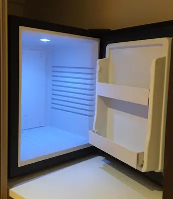 an empty refrigerator with its door open in a room at B&B-Les Balcons de Maragon in Carcassonne