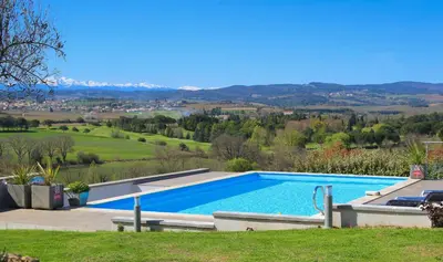 a swimming pool with a view of the hills at B&B-Les Balcons de Maragon in Carcassonne