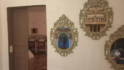 two mirrors hanging on a wall in a room at Les 2 Petits Lapins in Luc-sur-Orbieu