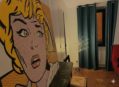 a painting of a woman on the wall in a living room at Les 2 Petits Lapins in Luc-sur-Orbieu