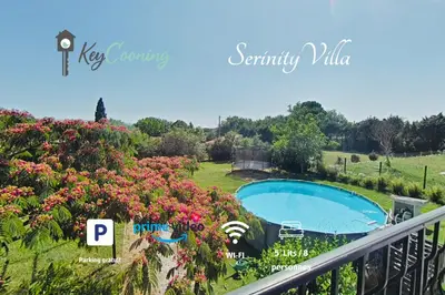 a view from a balcony of a swimming pool and flowers at Serinity Villa - Piscine - proche Castres in Viviers-lès-Montagnes