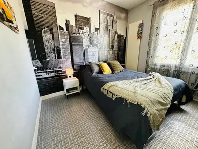 a bedroom with a bed and a city mural at Serinity Villa - Piscine - proche Castres in Viviers-lès-Montagnes