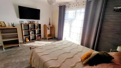 a bedroom with a bed and a large window at Serinity Villa - Piscine - proche Castres in Viviers-lès-Montagnes