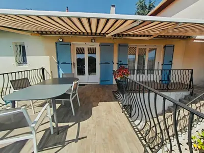 a patio with a table and chairs on a balcony at Serinity Villa - Piscine - proche Castres in Viviers-lès-Montagnes