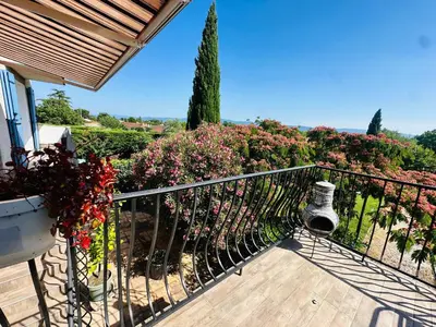 a balcony of a house with flowers at Serinity Villa - Piscine - proche Castres in Viviers-lès-Montagnes