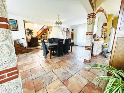 a living room with a table and chairs at Serinity Villa - Piscine - proche Castres in Viviers-lès-Montagnes