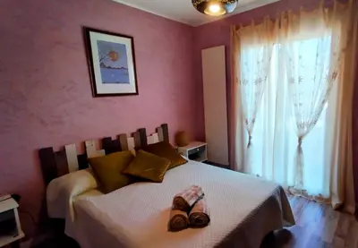 a bedroom with a bed with two pairs of shoes on it at Serinity Villa - Piscine - proche Castres in Viviers-lès-Montagnes