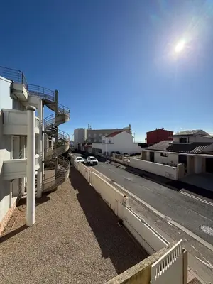 a view of a street with a building and a road at escapade les pied dans l'eau in Port-la-Nouvelle