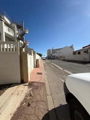 a white car parked on the side of a street at escapade les pied dans l'eau in Port-la-Nouvelle