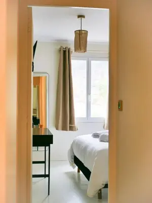 a bedroom with a bed and a desk and a window at Casa Bonnafous in Villesèque-des-Corbières