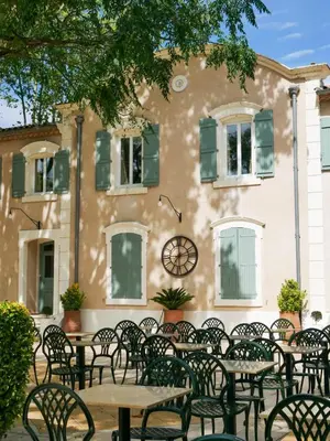 a group of tables and chairs in front of a building at Casa Bonnafous in Villesèque-des-Corbières