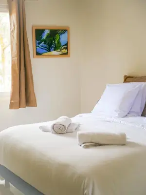 a white bed with towels on it in a bedroom at Casa Bonnafous in Villesèque-des-Corbières