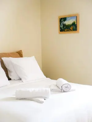 a bed with white sheets and towels on it at Casa Bonnafous in Villesèque-des-Corbières