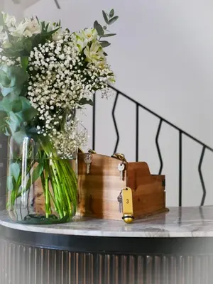 a table with a vase of flowers and a wooden box at Casa Bonnafous in Villesèque-des-Corbières