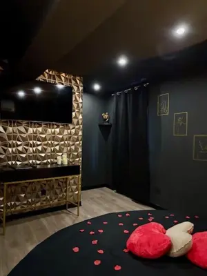 a bedroom with a bed with a blue light at Love Room L'instanté - 