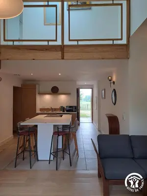 a kitchen and living room with a table and chairs at Gîte de l'atelier in Sorèze in Sorèze