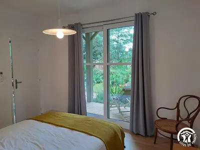 a bedroom with a bed and a large window at Gîte de l'atelier in Sorèze in Sorèze