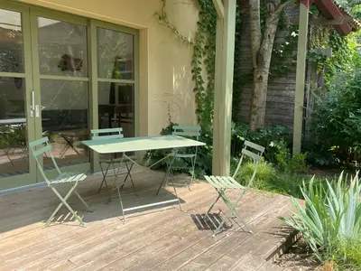 a table and chairs sitting on a deck at Gîte de l'atelier in Sorèze in Sorèze