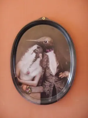a picture of a woman with a bird in a mirror at Lagrasse Romantic house, enclosed garden, pool in Lagrasse