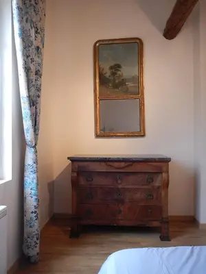 a bedroom with a dresser and a mirror on the wall at Lagrasse Romantic house, enclosed garden, pool in Lagrasse