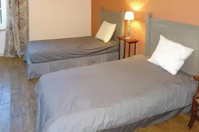 two beds in a room with a lamp and a bed at Lagrasse Romantic house, enclosed garden, pool in Lagrasse