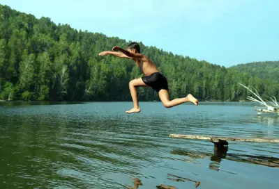 a young man jumping into a body of water at Maison Tranquil in Bellegarde-du-Razès