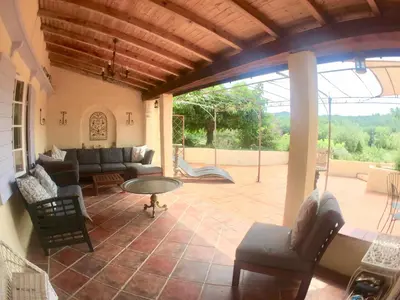 a patio with a couch and a table and chairs at Maison Tranquil in Bellegarde-du-Razès