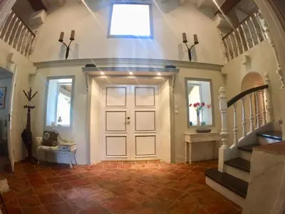 a large hallway with a door and stairs in a house at Maison Tranquil in Bellegarde-du-Razès