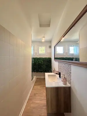 a bathroom with a sink and a mirror at Magnifique T3, OU Suite Elégance , à 4 min en voiture des Grands buffets in Narbonne