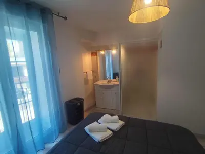 a bathroom with a bed with two towels on it at Vue sur la cité médiévale -Clim-Parking in Carcassonne