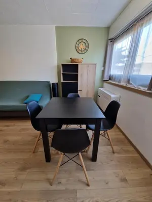 a kitchen with white cabinets and a washer at Appartement confort accès direct plage in Port-la-Nouvelle