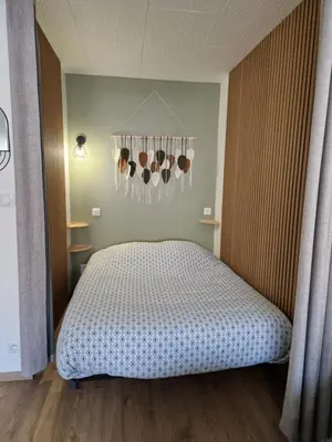 a kitchen with white cabinets and a washing machine at Appartement confort accès direct plage in Port-la-Nouvelle
