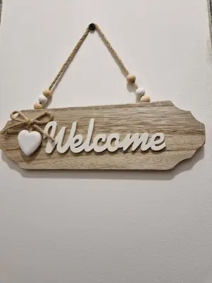 a wooden sign with the word welcome at Appartement confort accès direct plage in Port-la-Nouvelle
