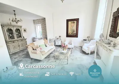 a living room with a couch and a fireplace at CAR-Volterra Cottage-AN in Carcassonne