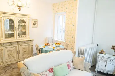 a living room with a white couch and a table at CAR-Volterra Cottage-AN in Carcassonne