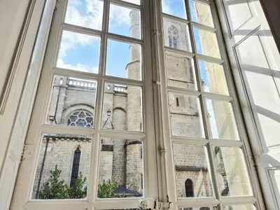 an open window with a view of a cathedral at CAR-Volterra Cottage-AN in Carcassonne