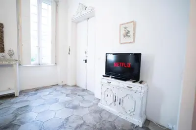 a television sitting on top of a cabinet in a room at CAR-Volterra Cottage-AN in Carcassonne