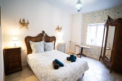 a bedroom with a bed with two stuffed animals on it at CAR-Volterra Cottage-AN in Carcassonne