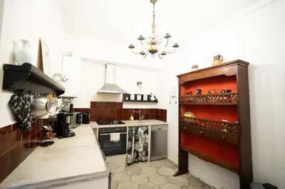 a kitchen with a stove top oven and a counter at CAR-Volterra Cottage-AN in Carcassonne