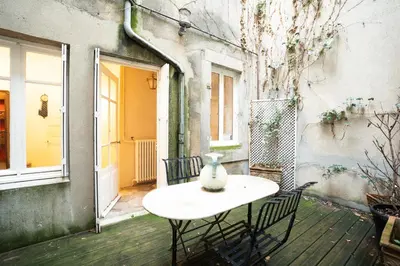 a vase sitting on a table on a patio at CAR-Volterra Cottage-AN in Carcassonne