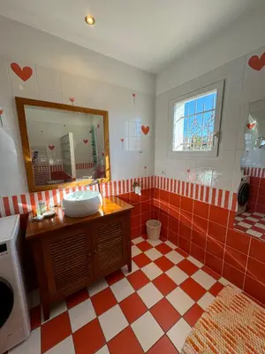 a bathroom with a red and white checkered floor at Villa Kéona , gîte 5 étoiles avec piscine privée et vue nature in Vingrau