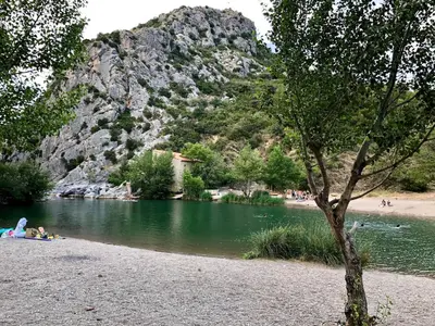 a group of people on a beach next to a river at Villa Kéona , gîte 5 étoiles avec piscine privée et vue nature in Vingrau