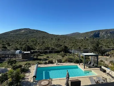 a swimming pool with a mountain in the background at Villa Kéona , gîte 5 étoiles avec piscine privée et vue nature in Vingrau