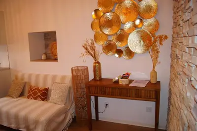 a room with a table and a chair and a mirror at Le Petit Capoine 3 - T2 en plein centre de Carcassonne in Carcassonne