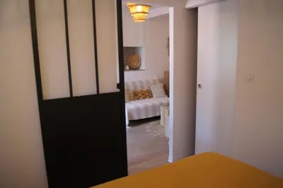 a room with a door leading to a living room at Le Petit Capoine 3 - T2 en plein centre de Carcassonne in Carcassonne