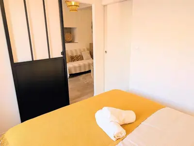 a bedroom with a bed with a towel on it at Le Petit Capoine 3 - T2 en plein centre de Carcassonne in Carcassonne