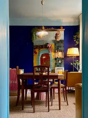 a dining room with a wooden table and chairs at La Casa De Frida charme & poésie in Narbonne