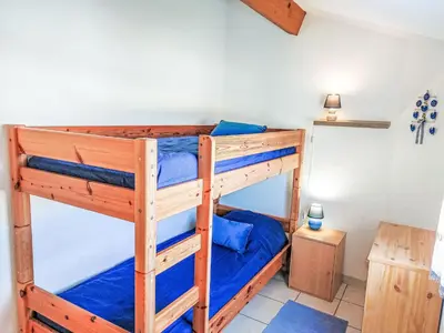 a bedroom with two bunk beds in a room at Holiday Home Bora Bora 2-3 by Interhome in Gruissan