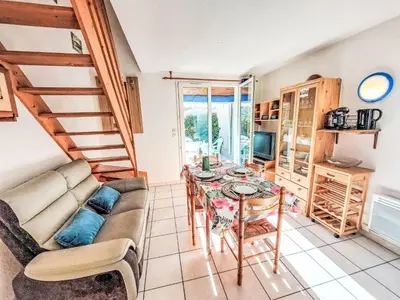 a living room with a table and a couch at Holiday Home Bora Bora 2-3 by Interhome in Gruissan